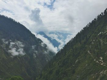 Scenic view of mountains against cloudy sky