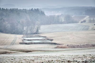 High angle view of trees on field against sky during winter