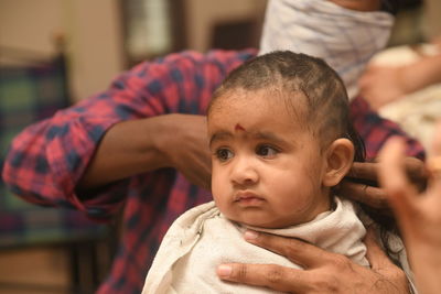 Hairdresser cutting baby hair