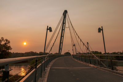 View of suspension bridge against sky during sunset