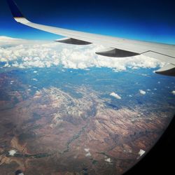 Cropped image of airplane wing over landscape