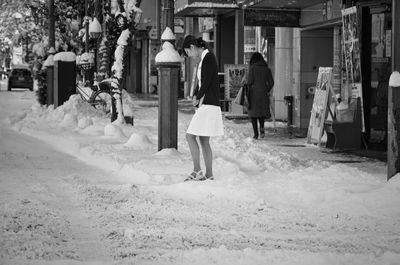 Rear view of woman walking in corridor