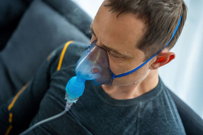 Close-up of young man wearing protective mask