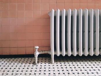 Metal radiator against wall