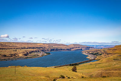 Scenic view of landscape against blue sky