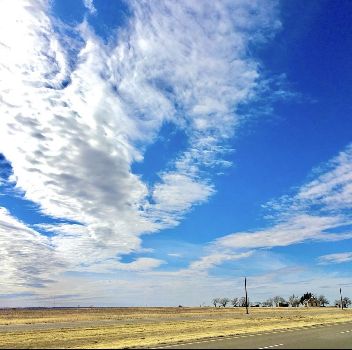 sky, horizon, cloud, environment, landscape, plain, prairie, field, nature, blue, scenics - nature, beauty in nature, grassland, land, road, no people, rural scene, day, tranquil scene, tranquility, transportation, outdoors, sunlight, horizon over land, plant, agriculture, rural area, non-urban scene, cloudscape, travel, grass, steppe, dusk