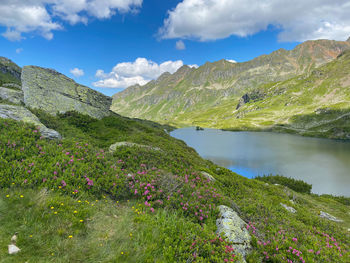 Scenic view of lake and mountains against sky