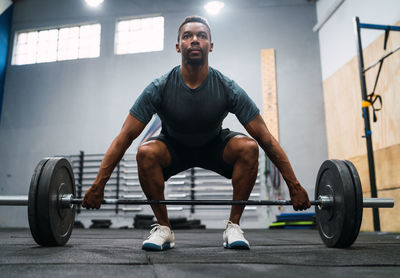 Full length of man exercising in gym