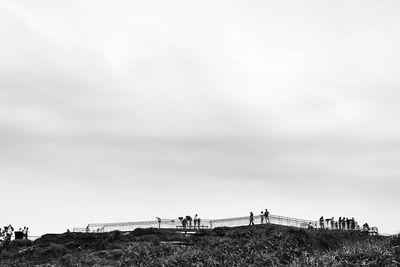 People on land against sky