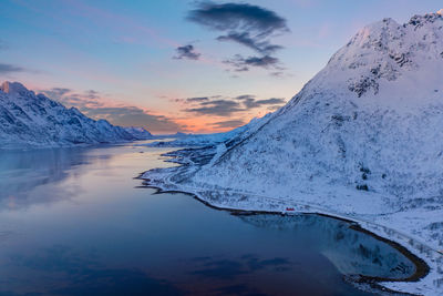 Scenic view of snowcapped mountains against sky during sunset