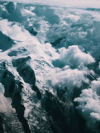 Aerial view of snowcapped mountains against sky