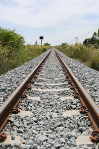 Surface level of railroad tracks against sky