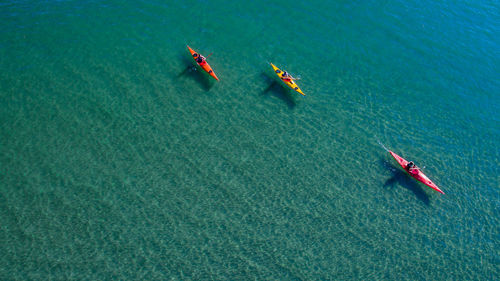 High angle view of people kayaking in sea