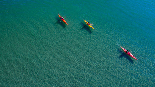Aerial view of people kayaking in sea