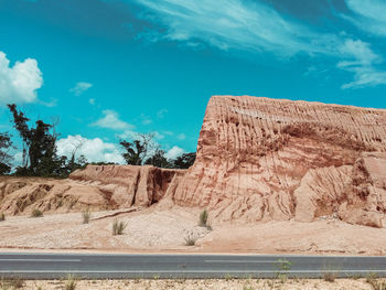 Rock formations in desert against blue sky