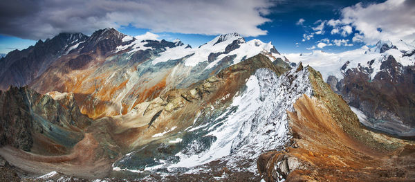 Close-up of snow on mountain against sky