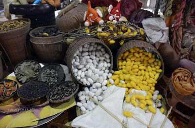 High angle view of silk cocoons in wickers