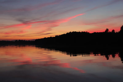 Scenic view of lake against romantic sky at sunset