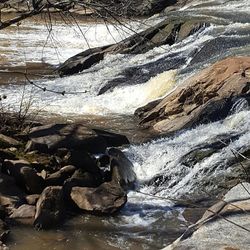 Scenic view of waterfall in river