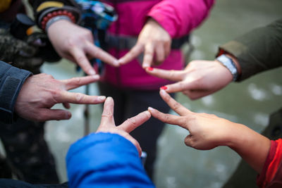 Friends making star shape with fingers