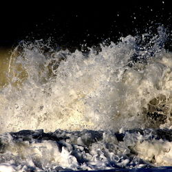 Close-up of water splashing against black background