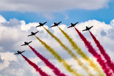 Low angle view of airshow against sky