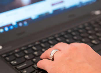 Close-up of hand using laptop