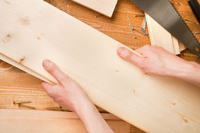 Close-up of hand on hardwood floor