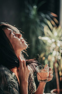 Midsection of woman drinking glass