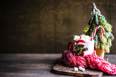 Christmas holiday flatlay with evergreen xmas tree and marshmallow on wooden background 