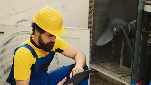 Side view of man working in factory