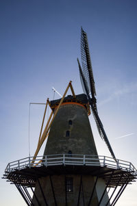 Low angle view of traditional windmill against clear sky