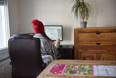 Young woman working from home in winter