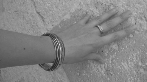 Cropped hand of woman showing ring and bracelet