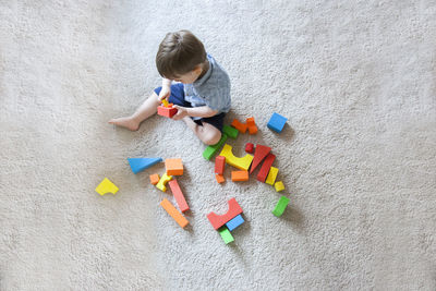 High angle view of boy playing with toys