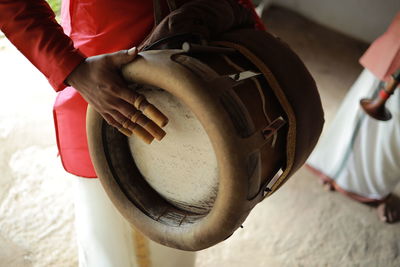 Cropped hand of man holding metal