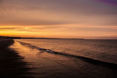 Scenic view of sea against sky at sunset