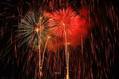 Low angle view of firework display at night