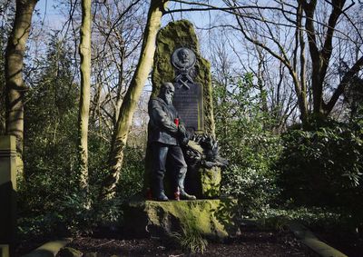 Statue against trees and sky