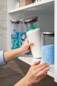 Cropped hands of woman holding glass