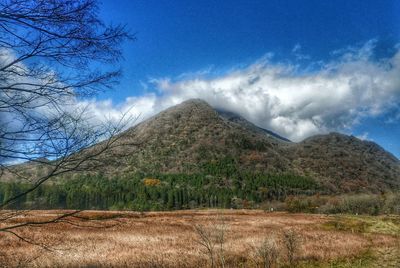 Scenic view of mountains against blue sky