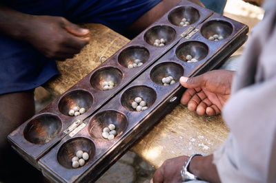 Midsection of men playing leisure games