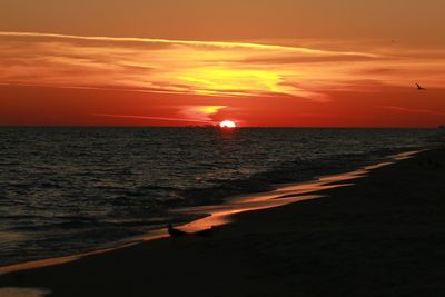 Scenic view of sea against romantic sky at sunset