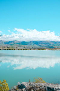 Scenic view of beach against blue sky