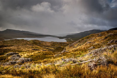 Scenic view of mountains against cloudy sky