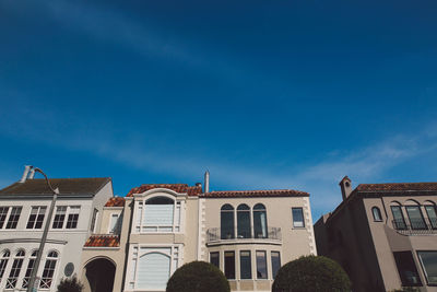 Low angle view of buildings against blue sky