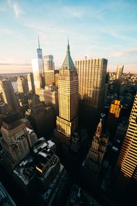 Aerial view of buildings in city against sky