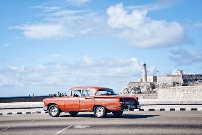 Cars on car against sky