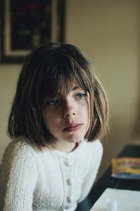 Portrait of girl looking away at home