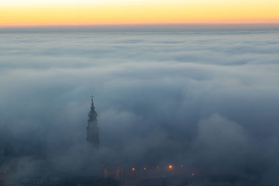 View of buildings against cloudy sky during sunset